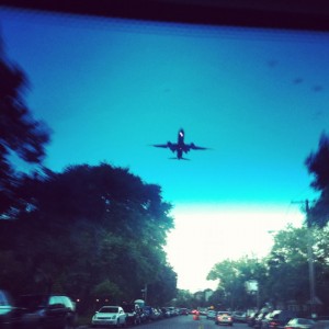 a plane flying over a street
