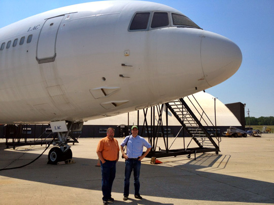 men standing next to a plane