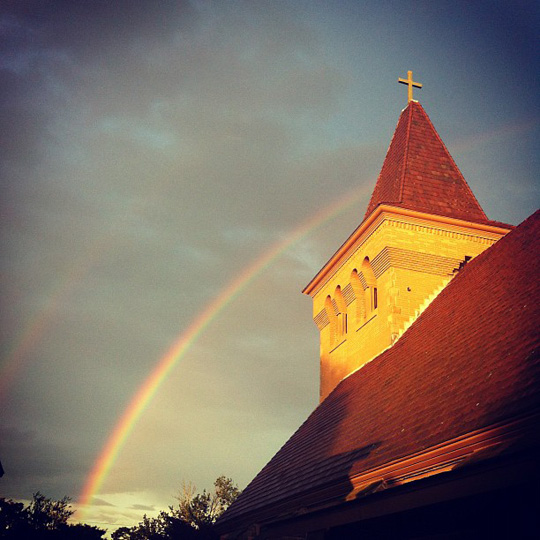 a rainbow over a church