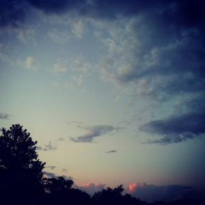 a cloudy sky over trees