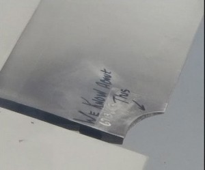 a piece of metal with writing on it