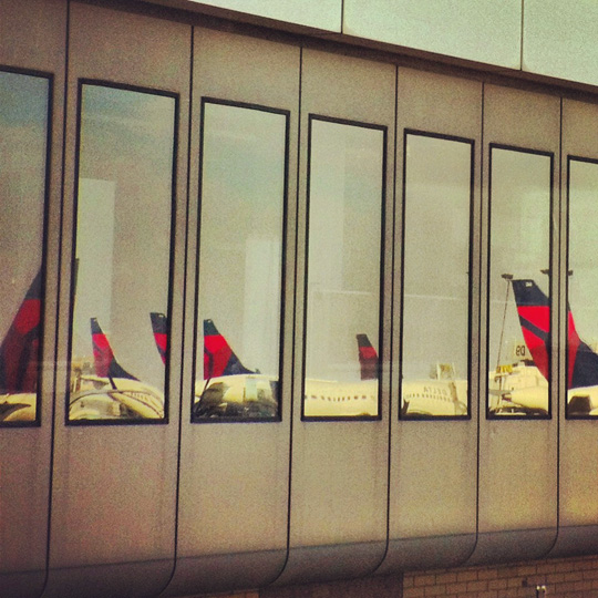 a row of windows with airplanes in them