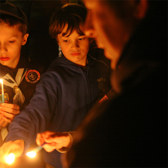 a group of people holding lit candles