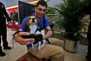 a man taking a selfie with a dog