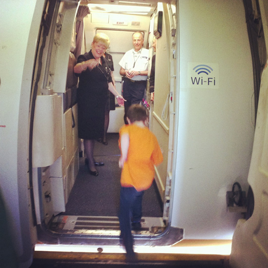 a child running through an airplane door