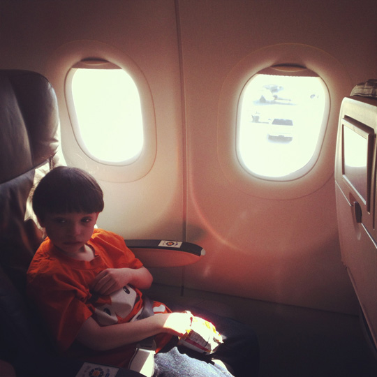 a boy sitting in an airplane