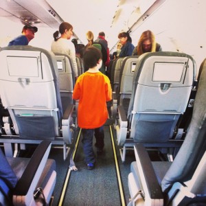 a child walking in an airplane