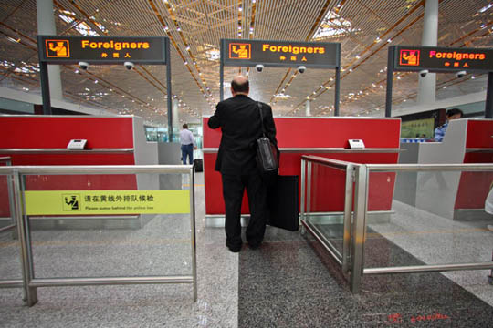 a man standing at a check-in counter